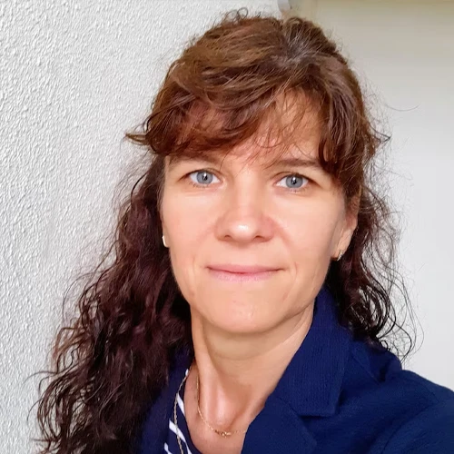 Photo of Brenda L., a 48-year-old woman smiling outdoors.